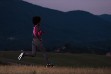 Image showing Young African american woman jogging in nature