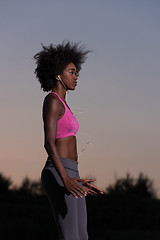 Image showing black woman is doing stretching exercise relaxing and warm up