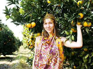 Image showing pretty islam woman in orange grove smiling, real muslim girl