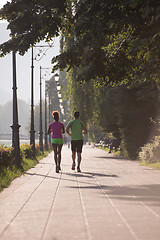 Image showing young multiethnic couple jogging in the city