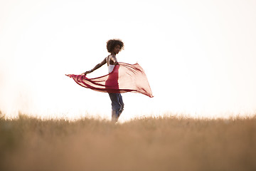 Image showing black girl dances outdoors in a meadow