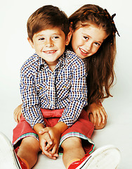 Image showing little cute boy and girl hugging playing on white background, ha