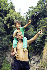 Image showing father and son making a trip to waterfall together, happy family