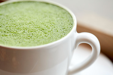 Image showing close up of cup with matcha green tea latte