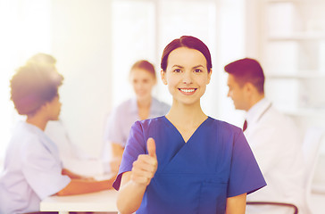 Image showing happy doctor over group of medics at hospital