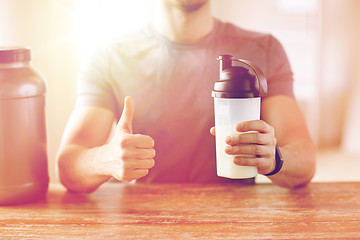 Image showing man with protein shake bottle showing thumbs up