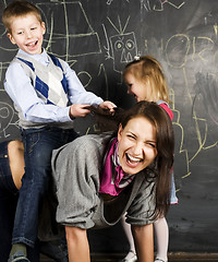 Image showing teacher with crazy kid in classroom fighting, lifestyle education people concept