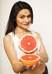 Image showing beauty young brunette woman with grapefruit isolated on white background, happy smiling healthy food concept, lifestyle people