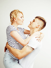 Image showing young pretty teenage couple, hipster guy with his girlfriend happy smiling and hugging isolated on white background, lifestyle people concept