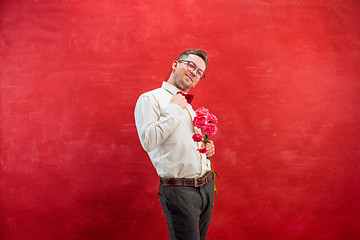 Image showing Young beautiful man with flowers