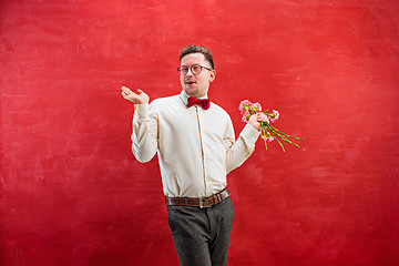 Image showing Young beautiful man with flowers