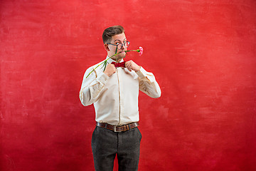 Image showing Young beautiful man with flowers