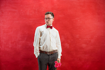 Image showing Young beautiful man with flowers