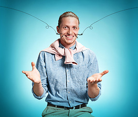 Image showing Happy excite young man smiling over blue background