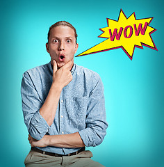 Image showing The surprised young man over blue background