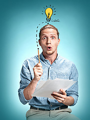 Image showing The surprised young man over blue background