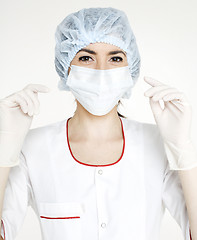 Image showing young pretty woman doctor with stethoscope wearing mask