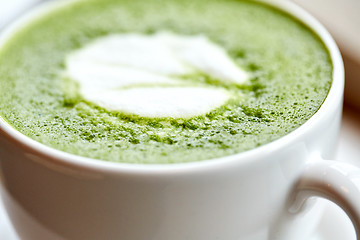 Image showing close up of cup with matcha green tea latte