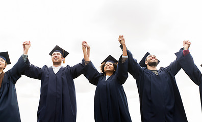 Image showing happy students or bachelors celebrating graduation