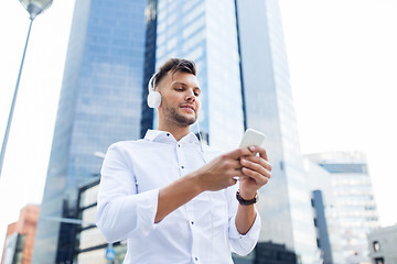 Image showing man with headphones and smartphone listening music