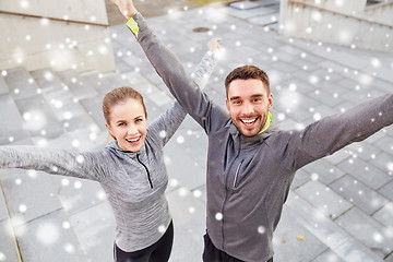 Image showing happy couple of sportsmen outdoors on city street