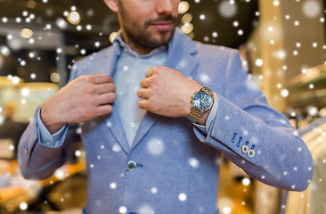 Image showing close up of man trying jacket at clothing store