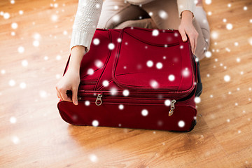 Image showing close up of woman packing travel bag for vacation