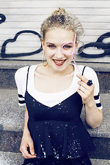 Image showing young pretty party girl smiling covered with glitter tinsel, fas