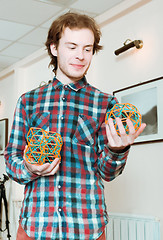 Image showing Young Man Holding The Volumetric Models Of Geometric Solids