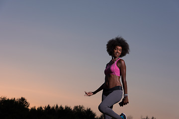 Image showing black woman is doing stretching exercise relaxing and warm up