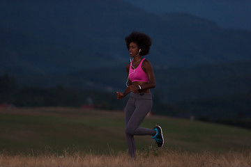 Image showing Young African american woman jogging in nature