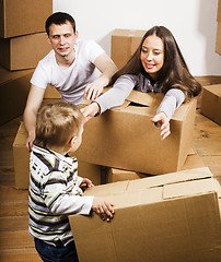 Image showing happy smiling family in new house playing with boxes little cute kid, lifestyle people concept