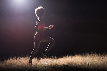 Image showing Young African american woman jogging in nature