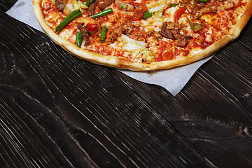 Image showing Homemade pizza on a wooden table