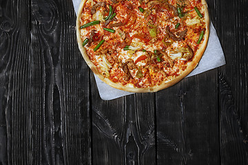 Image showing Homemade pizza on a wooden table