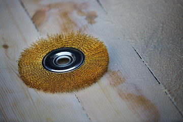 Image showing Grinding disk on a wooden planks