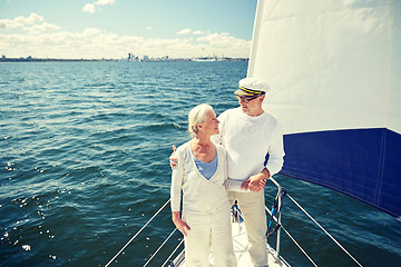 Image showing senior couple hugging on sail boat or yacht in sea