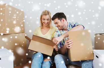 Image showing smiling couple with big boxes moving to new home