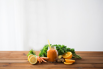 Image showing glass jug of carrot juice, fruits and vegetables