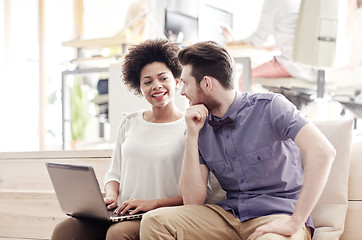 Image showing happy creative team with laptop in office