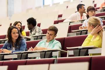 Image showing group of students with notebooks in lecture hall