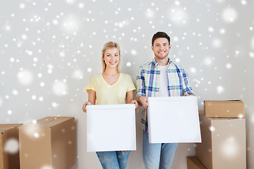 Image showing smiling couple with big boxes moving to new home