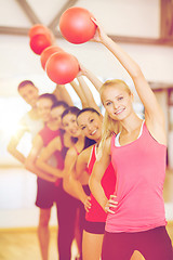 Image showing group of smiling people working out with ball