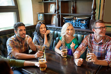 Image showing friends with beer watching football at bar or pub