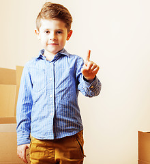 Image showing little cute boy in empty room, remoove to new house. home alone,