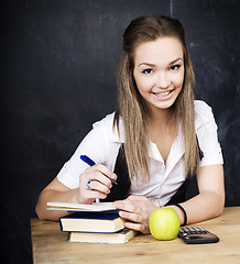 Image showing portrait of happy cute student with book in classroom