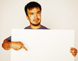 Image showing pretty cool asian man holding empty white plate smiling