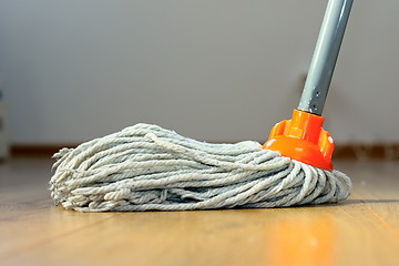 Image showing wet mop on wooden floor