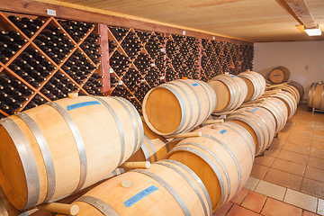 Image showing Wine Barrels and Bottles Age Inside Cellar