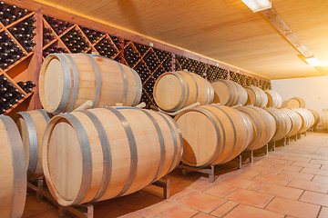 Image showing Wine Barrels and Bottles Age Inside Cellar